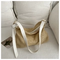 Close-up of woven straw tote bag with white leather strap and natural fiber texture - White