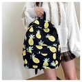 Girl wearing a black high-capacity backpack with cute yellow pineapple prints - Black