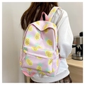 Pink backpack with yellow pineapple prints worn by a girl in a warm indoor setting - Pink