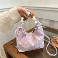 Lavender marble-patterned cloud bag with colorful beaded handle shown in hand - Pink