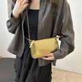 Metallic gold crossbody bag with silver studs and chain strap shown on model - Colorful