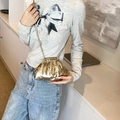 Mini metallic gold pleated cloud bag with slim shoulder strap worn by a model - Gold