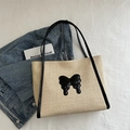 Large straw tote bag in off-white with black bow accents and dual shoulder straps - Black