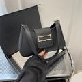 Minimalist black crescent hobo shoulder bag with a gold rectangular metal buckle - Black