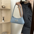 Sky blue underarm bag with silver bow accent shown in a stylish mirror selfie - Blue
