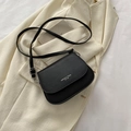 Minimalist black matte leather saddle bag for women with an adjustable strap - Black