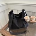 Black casual drawstring tote bag with a cute plush coffee cup charm on wooden surface - With Pendant / Black