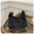 Close-up of black pleated crossbody bag with silver chain detail on a glass table - No Pendant / Black