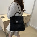 Minimalist black crinkled texture backpack with silver oval swivel lock and handle - Black