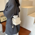 Straw bucket bag with pearl handle and cream woven texture for a summer casual look - White