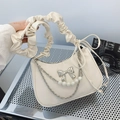 Chic cream cloud underarm bag with pleated handle and pearl chain detail on metallic background - Beige