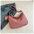 Detailed macro view of pink corduroy tote bag texture with matching circular coin purse - Pink