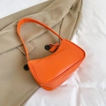 Vibrant orange faux leather hobo shoulder bag with zipper and slim strap on chic blazer - Orange
