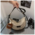 Detail of canvas crescent bag with black leather trim and a cute brown fur ball charm - With Pendant / Gray
