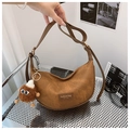 Detail of brown PU crescent bag featuring a monster plush charm and gold zipper - With Pendant / Dark Brown