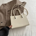 Chic off-white lychee texture crossbody bag with embossed Fashion lettering and top handle - Off White