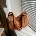 Brown corduroy hobo shoulder bag with a small matching round coin purse on a window sill - Tan