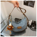 Detail of denim hobo bag with brown leather trim and a cute plush monster charm - With Pendant / Denim Blue