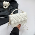 White quilted crossbody bag with top handle and gold hardware for modern women - White