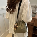 Army green pleated drawstring bucket bag with bear pendant and black shoulder strap - With Plush Pendant / Green