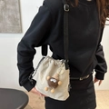 Beige drawstring crossbody bag with adjustable black strap and brown plush charm - With Plush Pendant / Khaki