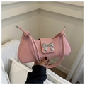 Detail of pink baguette bag with silver bow buckle and decorative rope handle knots - Pink