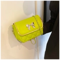 Detail of lime green quilted small square bag with silver metal butterfly decoration - Green