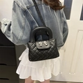 French quilted crossbody bag in black with metallic bow accent and top handle - Black