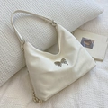 Elegant cream white tote bag with metallic butterfly detail and soft leather finish - Off White