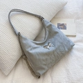 Chic light gray shoulder bag with metallic butterfly detail and crinkled texture - Silver