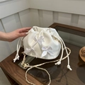 White pleated bucket bag with satin bows and gold-tone chain strap for women - White