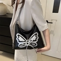 Y2K black shoulder bag with silver butterfly applique and lace-up metallic details - Black
