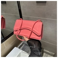 Detail of a bright pink rectangular shoulder bag with curved stitching and gold hardware - Rose Pink