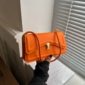 Vibrant orange rectangle shoulder bag with gold clasp and elegant shadow patterns - Orange