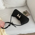 Minimalist black matte leather underarm bag with silver metal bow and knotted strap - Black