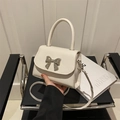 Mini white leather crossbody bag with silver metal bow and detachable shoulder strap - White