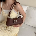 Deep brown matte leather crescent underarm bag with decorative silver metal bow - Brown