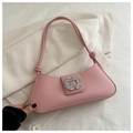 Close-up of pink baguette bag with sparkling crystal buckle on a white blazer background - Pink