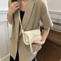 Chic cream-white PU leather crossbody bag with curved flap and textured matte finish - Off White