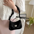 Chic black shoulder bag with silver butterfly buckle and pleated ruffle strap detail - Black
