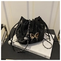 Detail of black drawstring bucket bag with silver butterfly charm and chain strap - Black Without Pendant