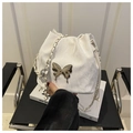 Detail of white bucket bag with gold liquid metal butterfly and chain strap - White Without Pendant