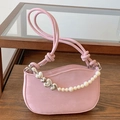 Pink shoulder bag with pearl chain and silver heart detail on elegant wooden shelf - Pink