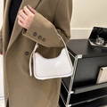 Chic white crocodile embossed leather hobo bag worn by a model in casual winter outfit - White