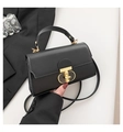 Detail of elegant black square handbag with golden metal clasp and leather texture finish - Black