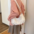 Minimalist white leather tote bag with a cute plush bear charm and side brand label - Beige Without Charm