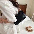 Minimalist black faux leather baguette bag with gold hardware and adjustable strap - Black