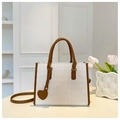 Detail of white quilted tote bag with brown leather trim and heart charm accessory - Off White