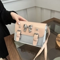 Fashionable two-tone crossbody bag with silver bow and dual buckle straps in beige - Pink and Silver