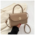 Detailed view of vintage crossbody bag with gold round clasp and leather top handle - Khaki